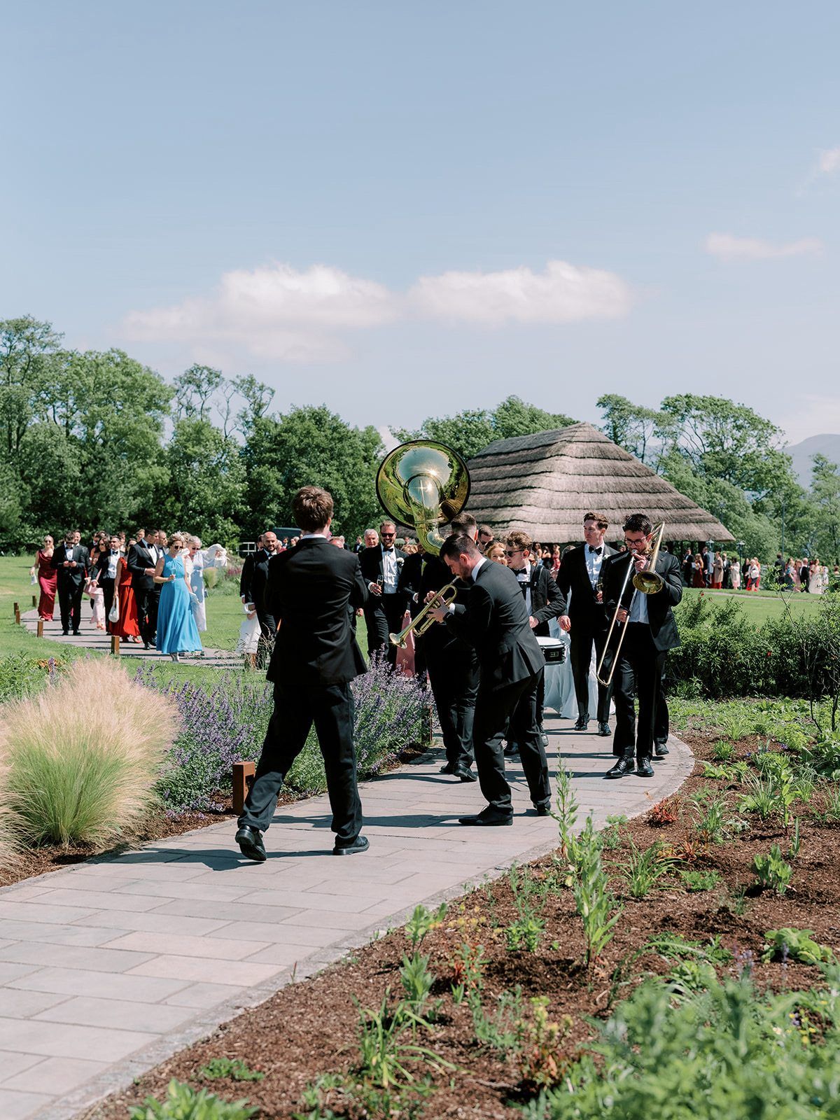 Brasswork leading wedding guests through the gardens