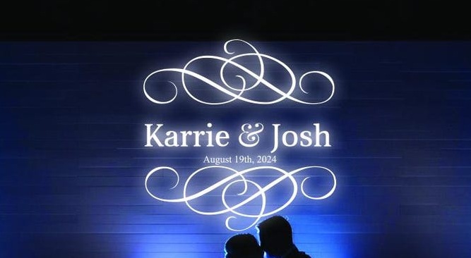 Custom gobo projection of the couple's names on a reception wall